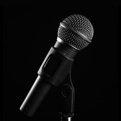 pexels-jaasiel-mora-750006729-400 A close-up of a stage microphone on a black background.